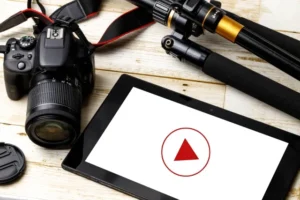 一眼レフカメラと三脚、白い再生マークが表示されたタブレット